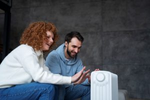 K L Contractor Plumbing Inc | How Long Should a Water Heater Last in Marietta, GA? – KL Plumbing & Construction Medium shot couple warming up with heater